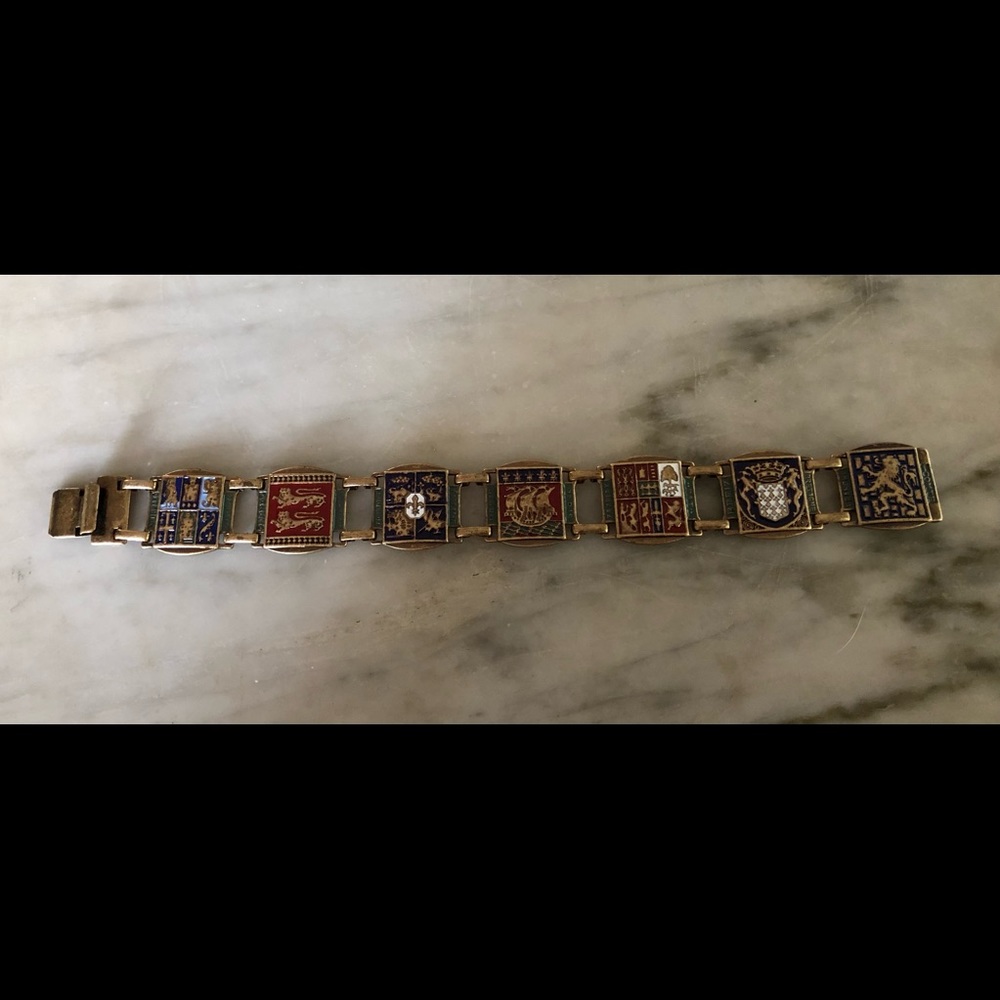 Distinctive metal link bracelet w/ European motifs. 7 1/2” long.  Slide close.